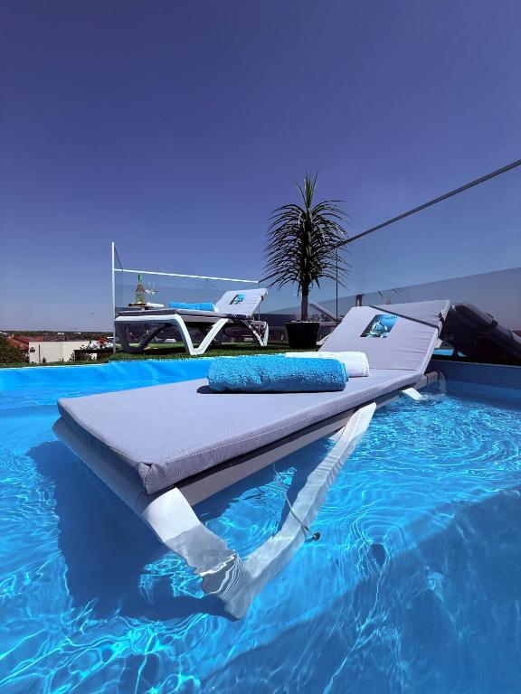 a bed sitting on top of a swimming pool at Jas Pipera Studio & Private Pool in Voluntari