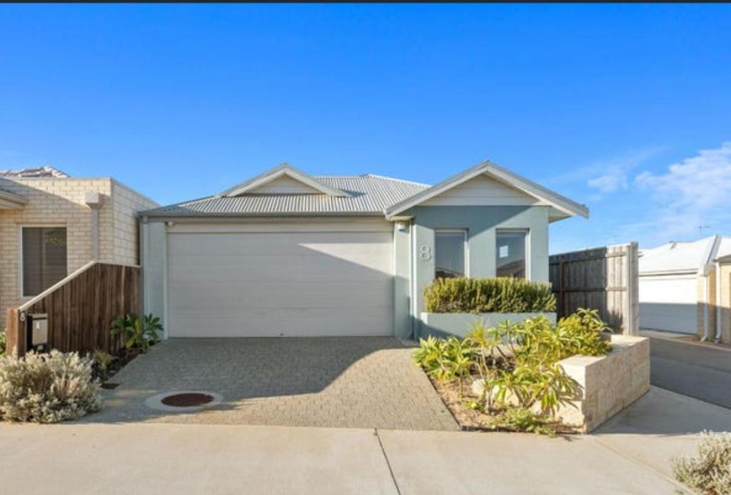 a house with a garage and a driveway at Seascape Beach House Retreat in Falcon