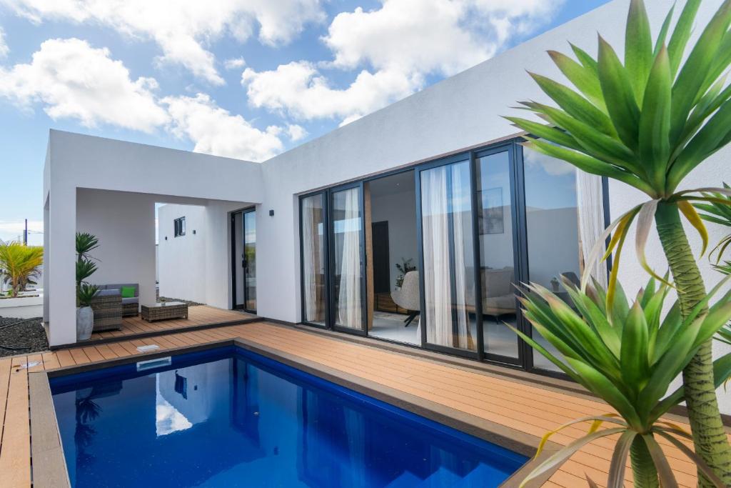 a house with a swimming pool and a villa at Rocky 39 in Grand-Baie