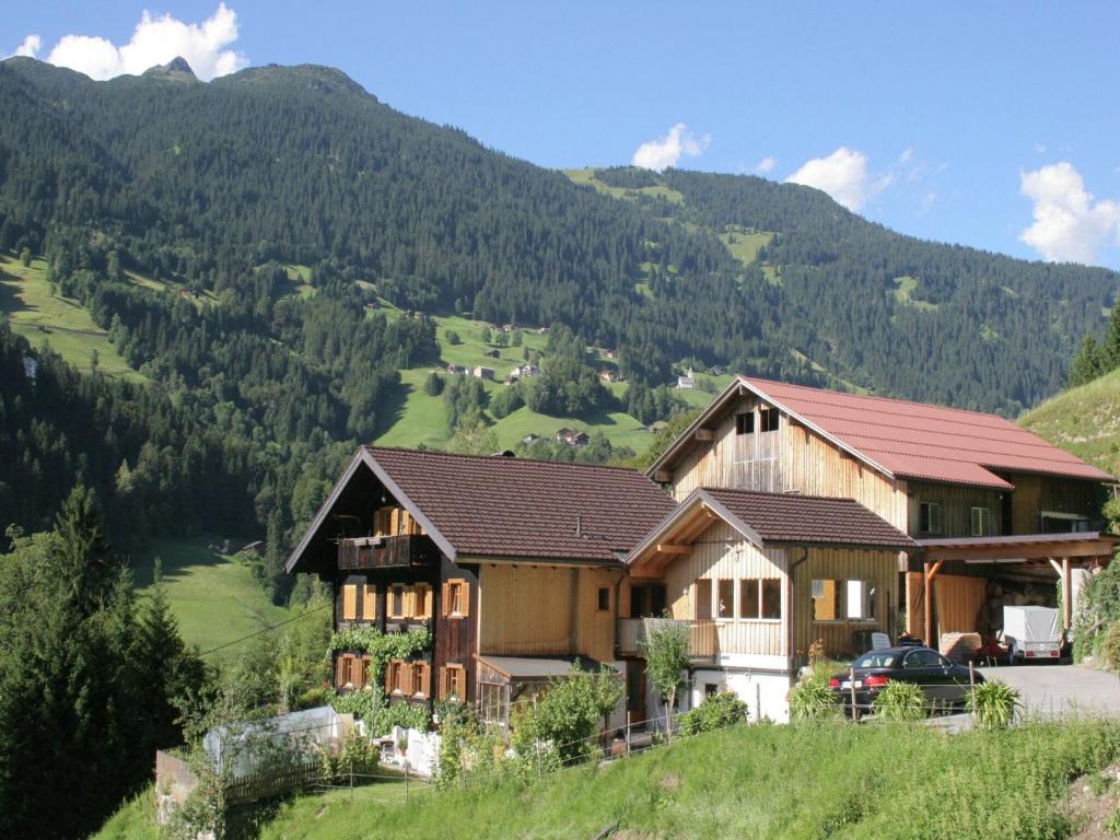 a house on a hill with mountains in the background at Chalet in Schruns near Montafon Ski Lift in Schruns