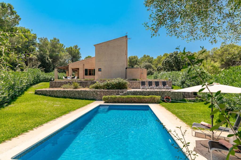 a swimming pool in front of a house at Villa Comellar by Sealand Villas in Artá