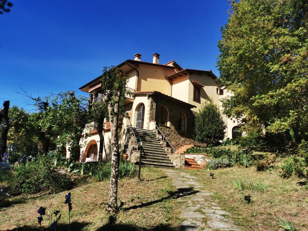 an old house on a hill with stairs in front at Villa Rosanna - views and woods near Florence in San Donato in Collina