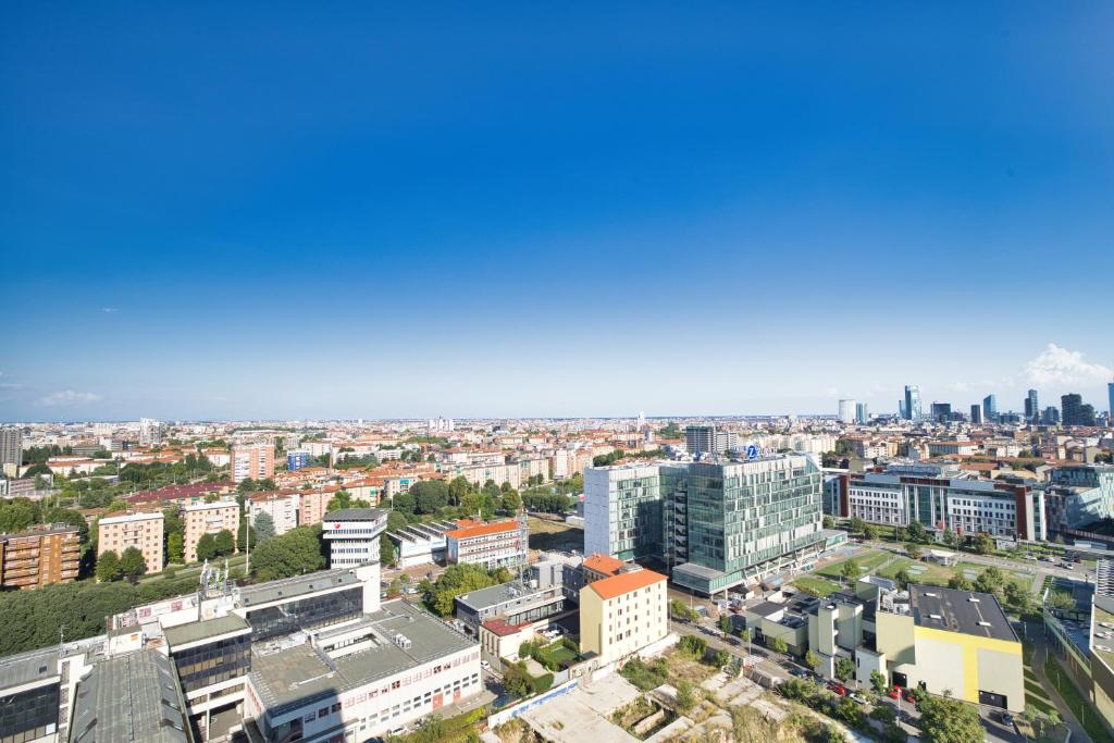 an aerial view of a city with buildings at GiaxTower Gym Spa & Pool Skyline View 20' piano in Milan