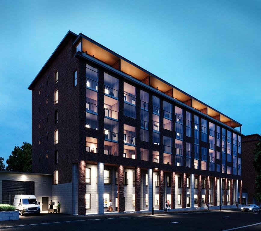 a large brick building with a van parked in front at Snownest Premium City Centre Apartments 2 in Rovaniemi