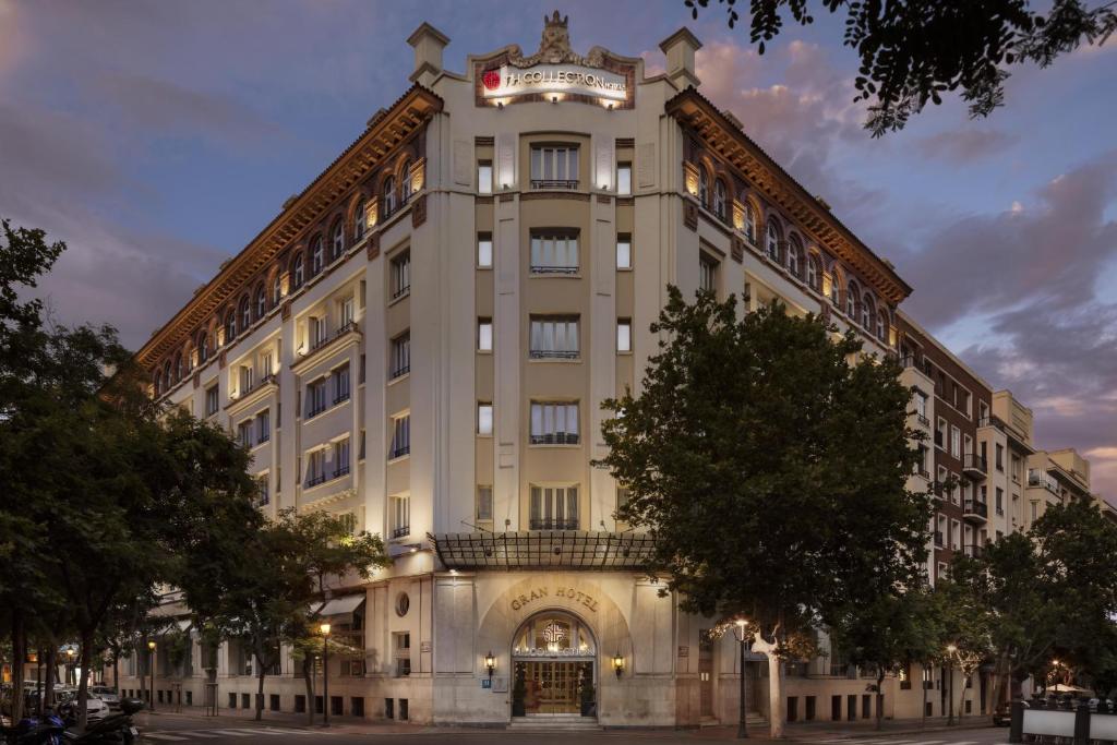a large building with a clock on top of it at NH Collection Gran Hotel de Zaragoza in Zaragoza
