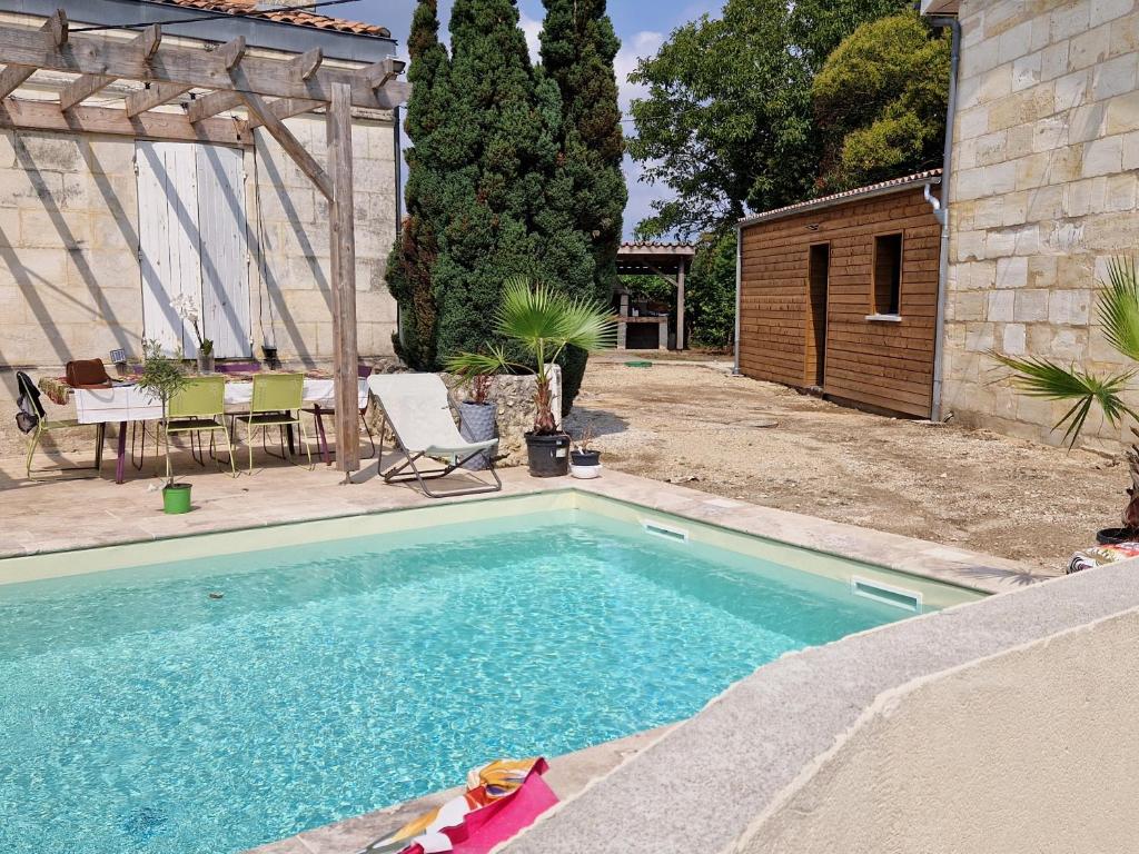 a swimming pool in the backyard of a house at Domaine de La Garde in Saint-Germain-de-la-Rivière