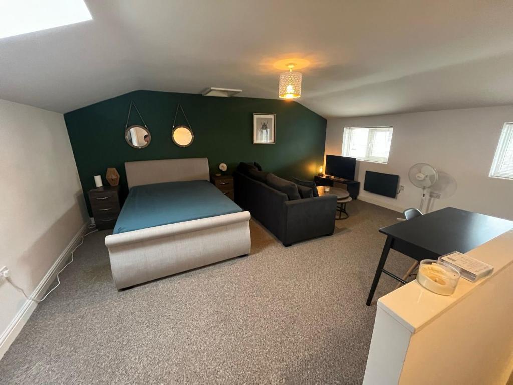 a living room with a bed and a couch at Sandcastle in Swansea
