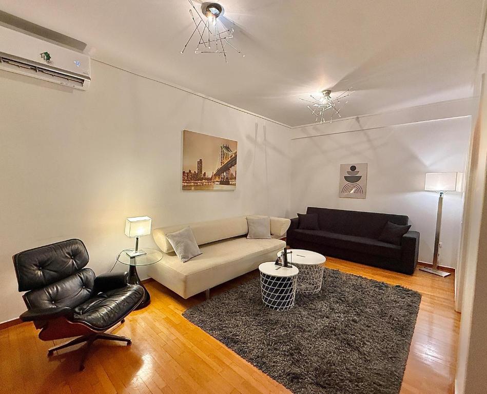a living room with a couch and a chair at Central Glyfada 2BR Apartment in Athens