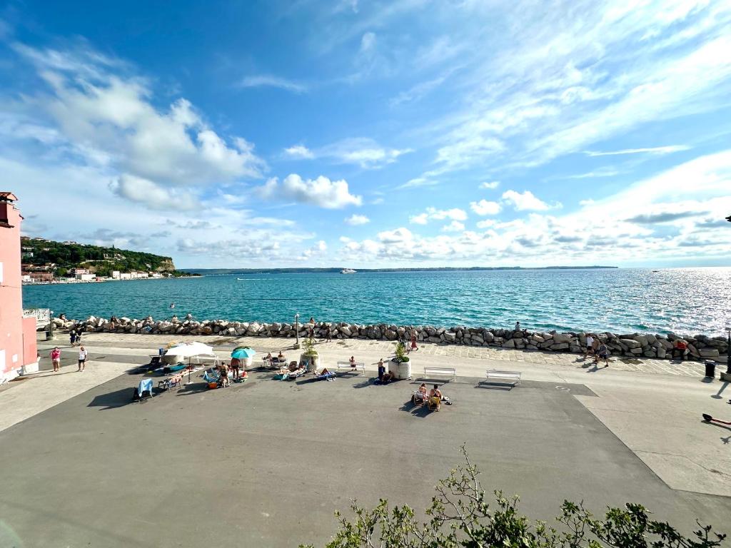 a group of people on a beach near the water at Casa Valentina in Piran