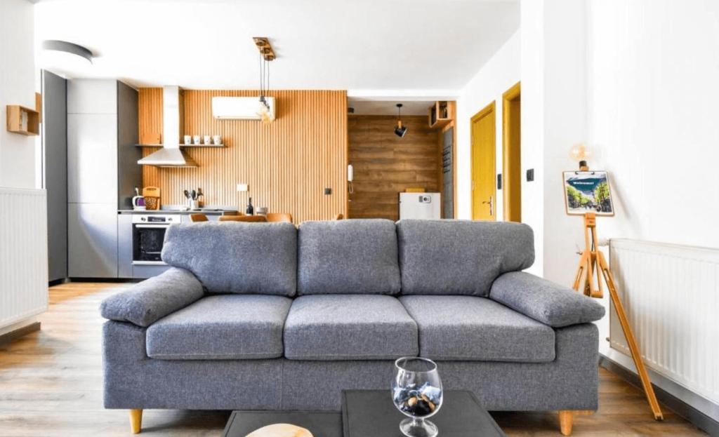 a living room with a couch and a kitchen at New Building, Free Parking Perfect For Families in Sofia