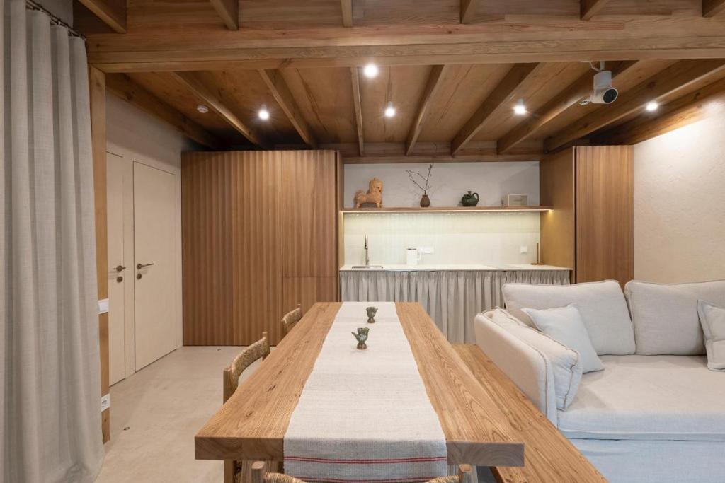a living room with a wooden table and a couch at Zarichka in Zachepilovka