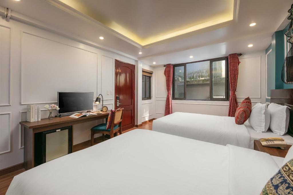 Giường trong phòng chung tại Glow Sapa Hotel
