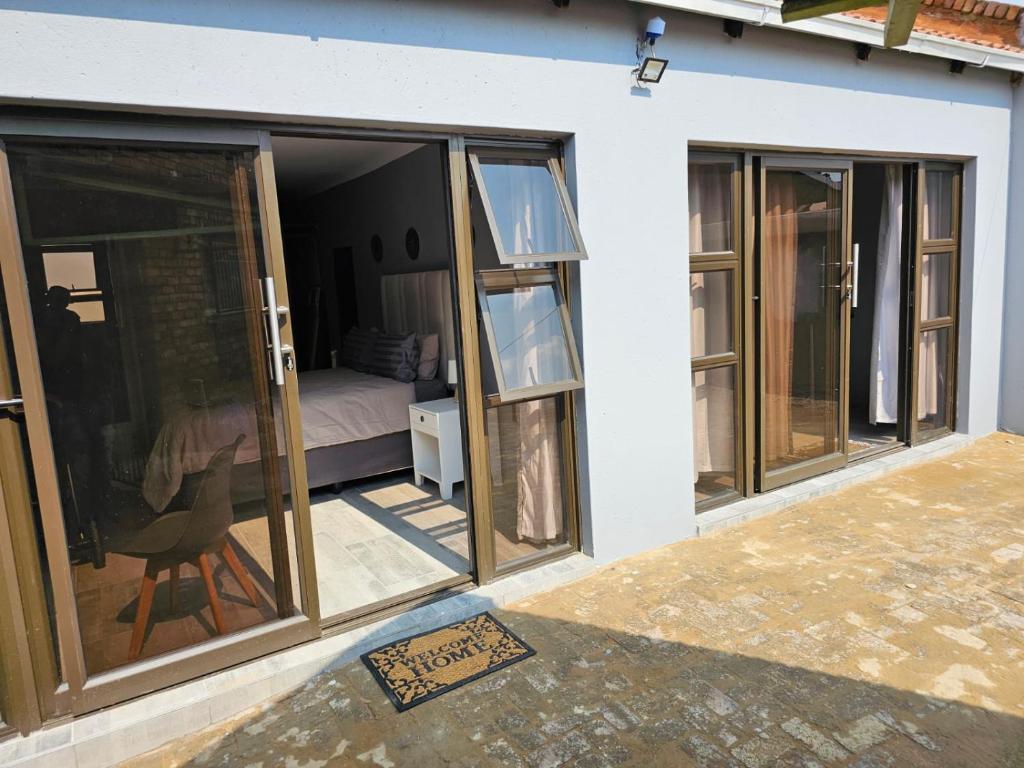a room with sliding glass doors and a bedroom at Lanico in Witbank