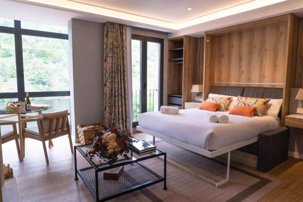 a bedroom with a bed and a table and a desk at Loureira in Pincelo
