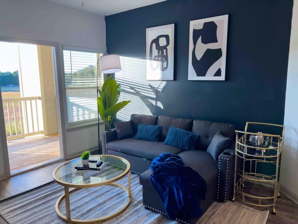 a living room with a couch and a glass table at Upscale King 3 Bed Suite to Uptown Charlotte in Charlotte