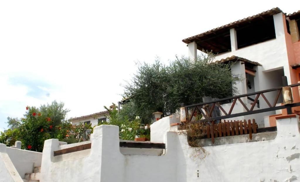 a white house with stairs and plants on it at Arcaidu Apartment Mit Bezaubernder Aussicht in Porto Columbu - Perdʼe Sali