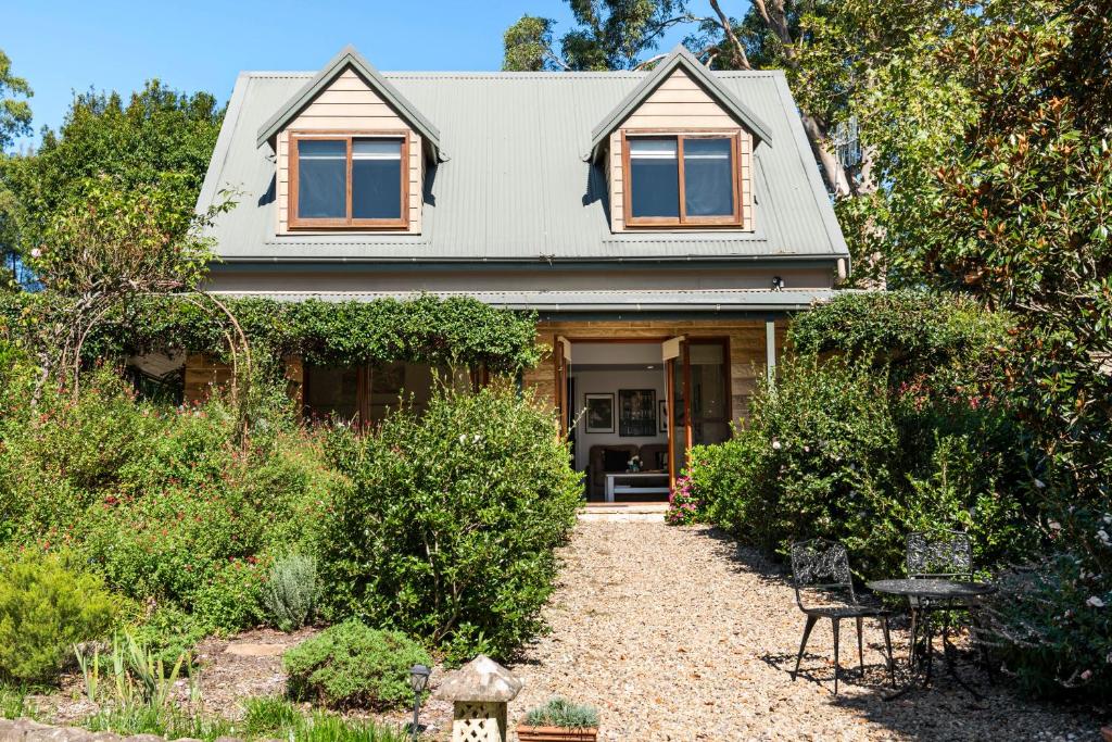 贝利Berry Beach Holiday Cottage的一栋房子前面有一条碎石车道