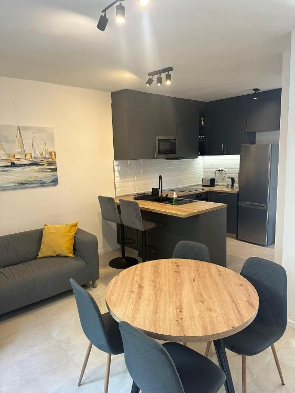 a kitchen and living room with a table and chairs at Eureka in Crikvenica