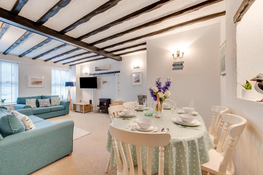 a living room with a table and chairs at 3 Bed in Croyde oc-2ingle in Croyde