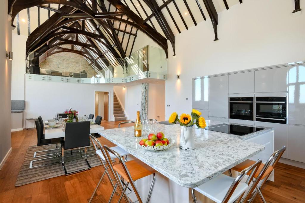 a kitchen with a table with a bowl of fruit on it at St Aelrhiws Church in Rhiw