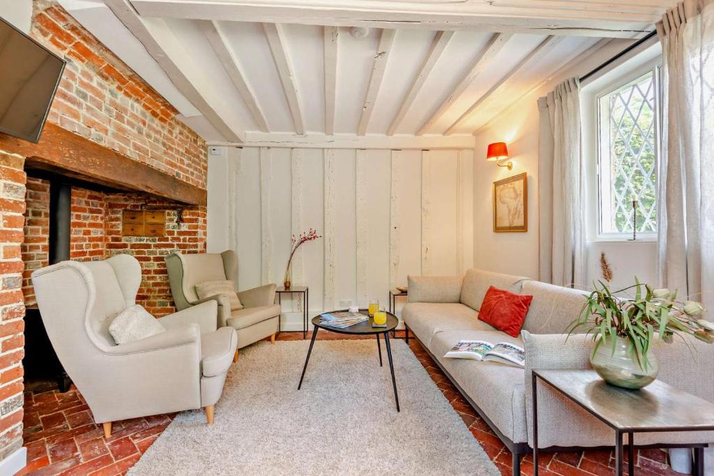 a living room with a couch and chairs at Corner Cottage - Kent in Benenden