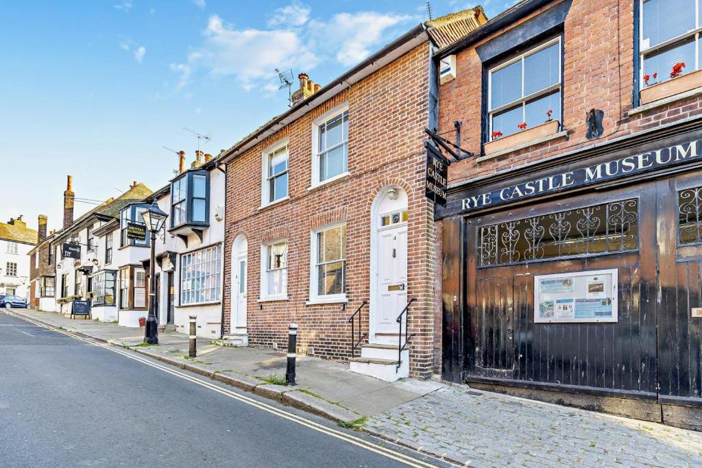 a brick building on the side of a street at Crown Cottage - Rye in Rye