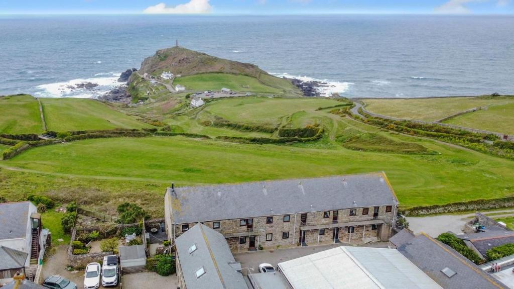 an aerial view of a building next to the ocean at Headland View in Botallack