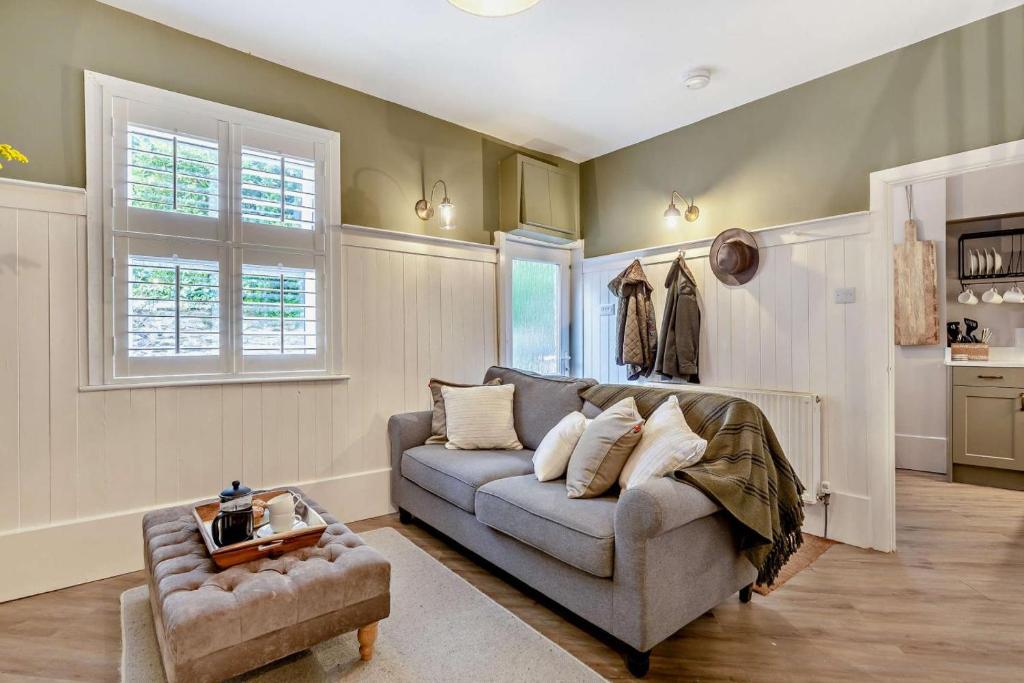 a living room with a couch and a chair at Trehawn Cottage in Saint Columb Major
