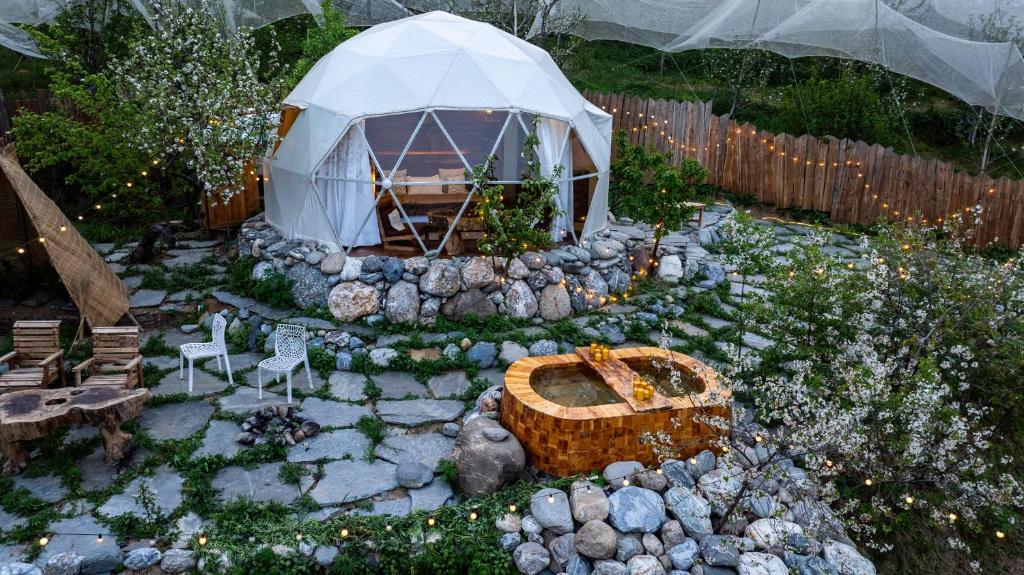 a garden with a igloo and a tent at Glamoreo - The Walnut Glamp in Cheog