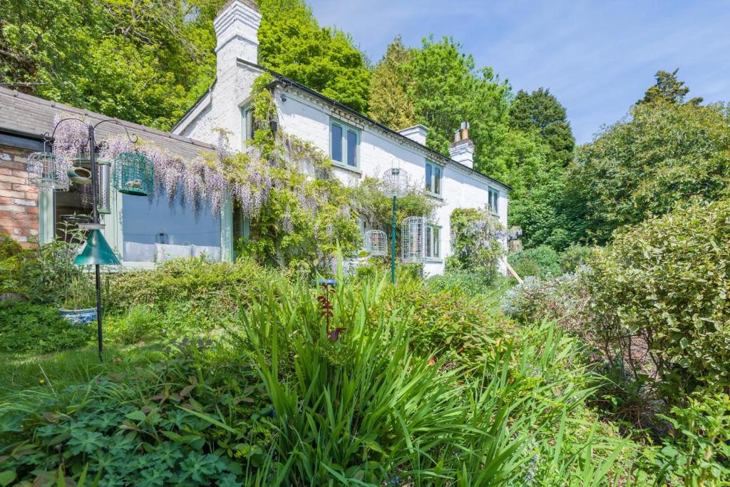 an old house with a garden in front of it at Laurel Cottage - The Retreat in Malvern Wells