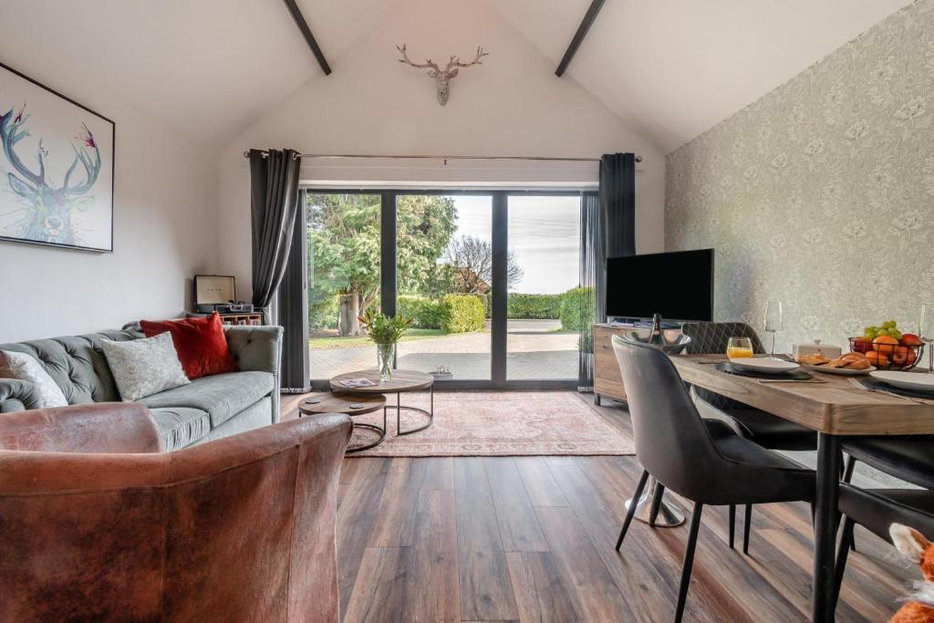 a living room with a couch and a table at Westfield Retreat in Hunmanby