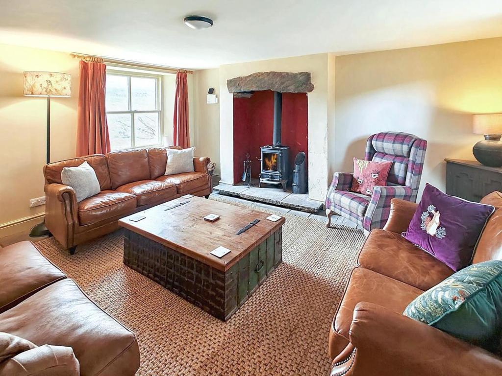 a living room with a couch and a coffee table at Low Moor Farm in Cotterdale