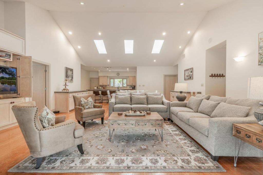 a large living room with couches and a table at Ultimate Hill Country Retreat, POOL, Creek, Sleeps 10 in Dripping Springs