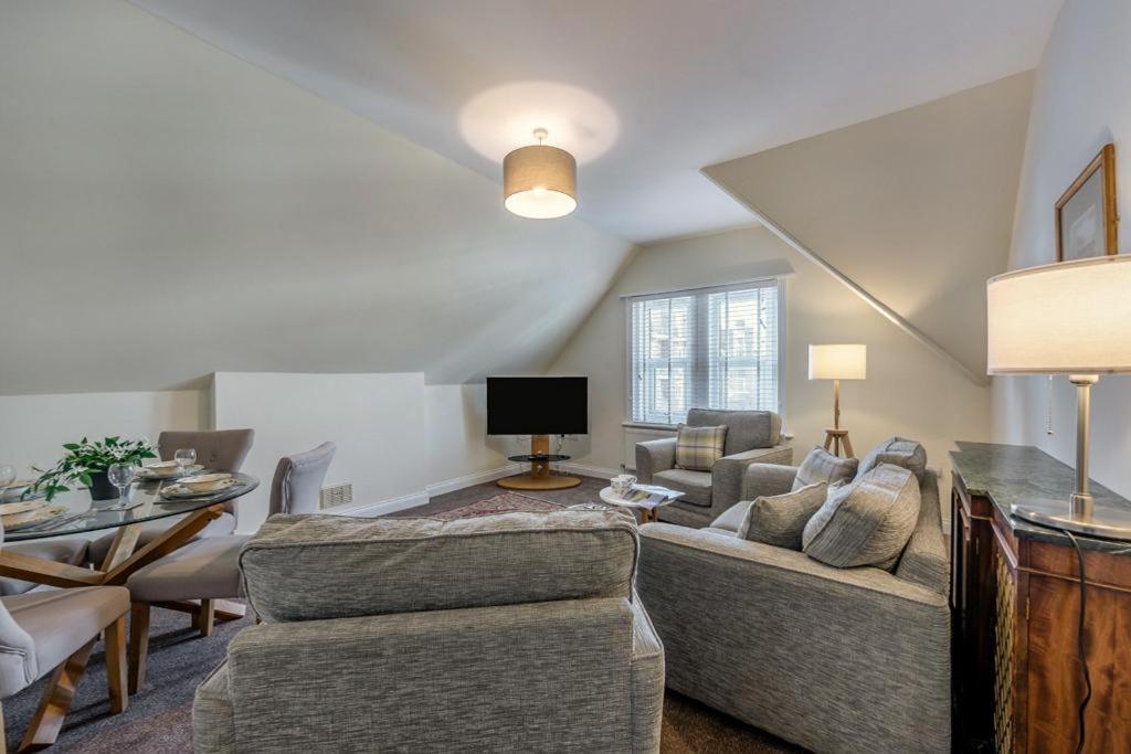 a living room with a couch and a table at Seabreeze - Bexhill on Sea in Bexhill