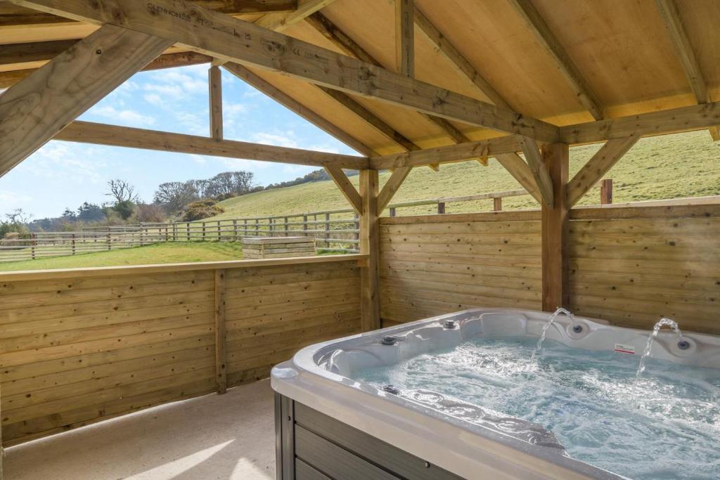 a large jacuzzi tub in a wooden building at Orchard House - Cockermouth in Embleton