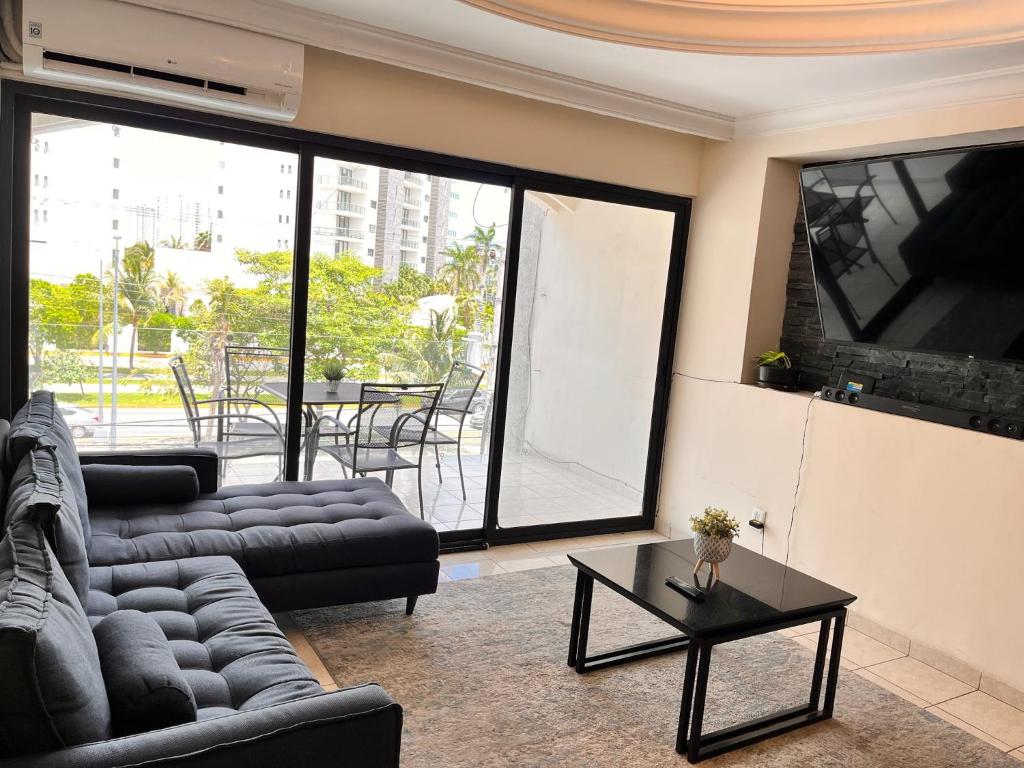 a living room with two couches and a table at Casa Bonampak 1 in Cancún