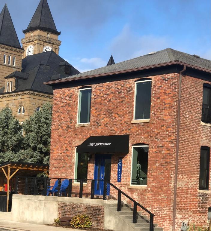 a brick building with a clock tower in the background at The Tiptonian in Tipton