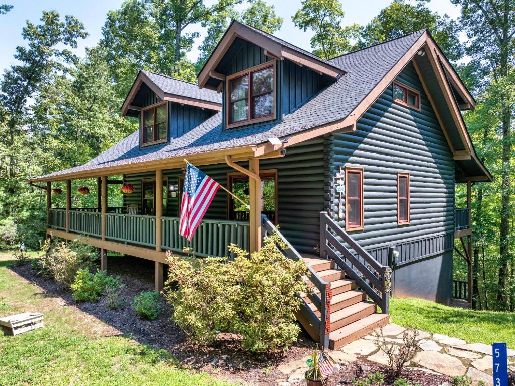 a house with a flag on the front of it at The Holiday Cabin at Lake Lure in Lake Lure
