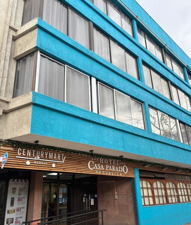 a blue building with a sign in front of it at Casa Paraíso Republica in Santiago