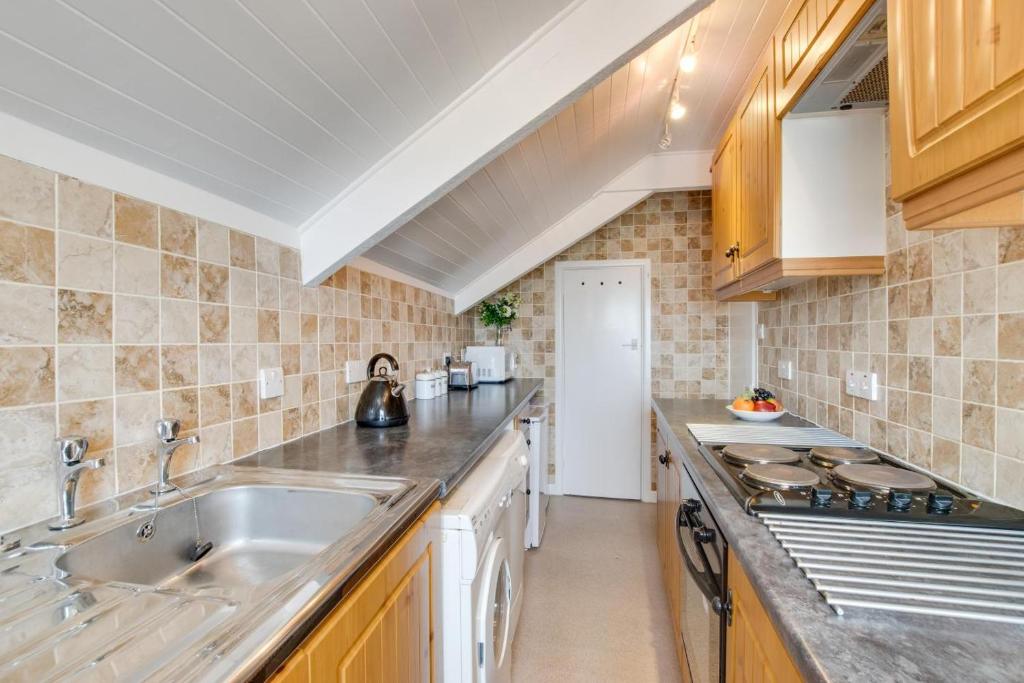 a kitchen with a sink and a counter top at West Pier Flats in St Ives