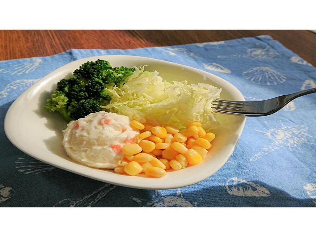 a plate of food with broccoli and corn and a fork at Smile Hotel Kobe Motomachi - Vacation STAY 05029v in Kobe