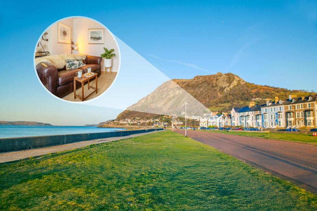 a picture of a beach with a couch and a building at Trem Y Fam in Llanfairfechan