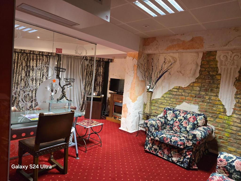 a living room with a couch and a chair at LEGENDS Chambers by Grand Pier Boutique in Bucharest
