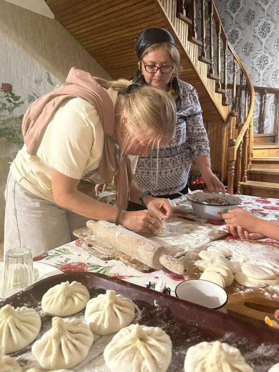 two women standing around a table making dough at Maia's Farmstay in Dedoplis Tskaro