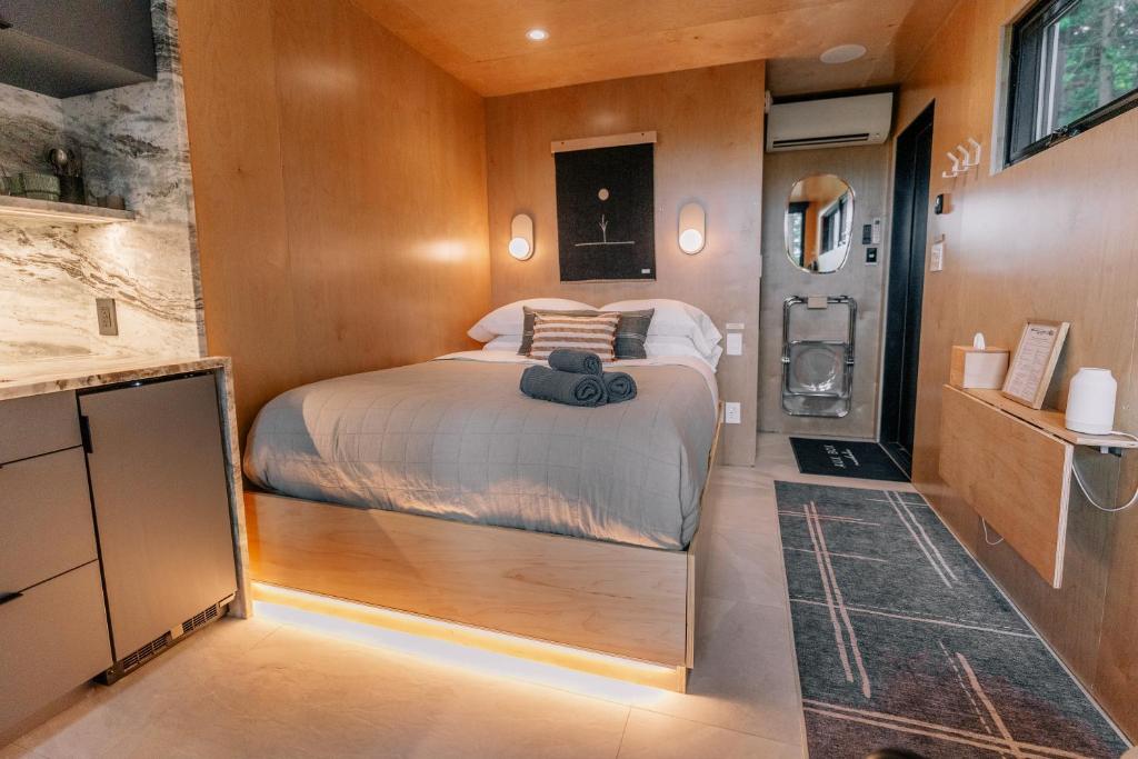 a bedroom with a bed in a small room at Aux Box Muskoka Modern Muskoka Bunkie in Huntsville