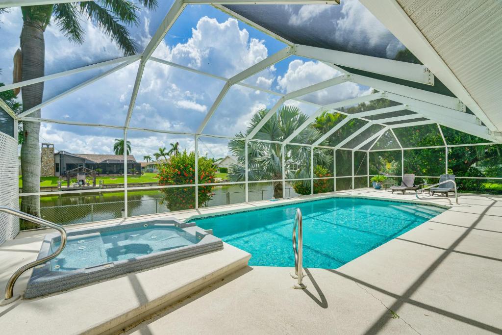 a swimming pool in a glass house with a hot tub at Near Sun Splash Waterpark Coral Princess Oasis in Cape Coral