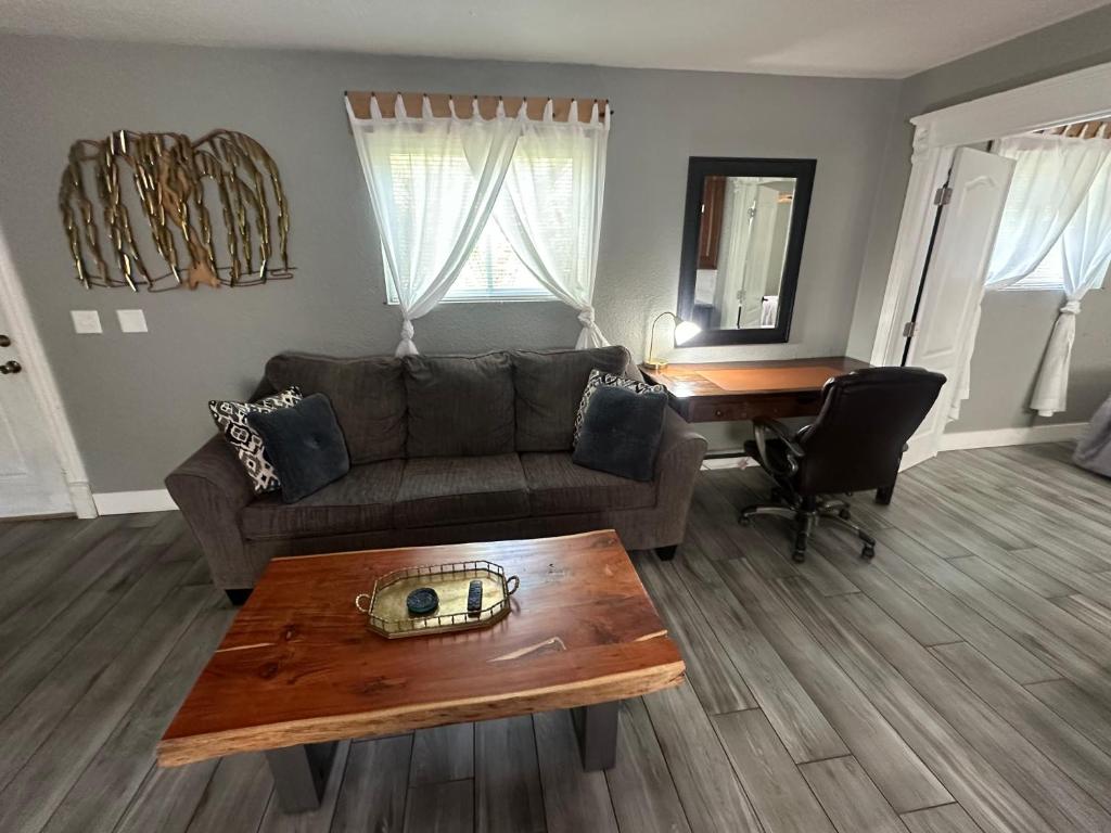 a living room with a couch and a table at Tropical Mountain Valley Casita in Mesa