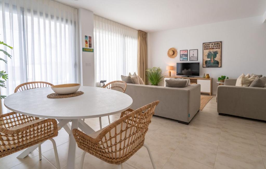 a living room with a white table and chairs at Experience Elevated Living at this Pure South Penthouse in Manilva