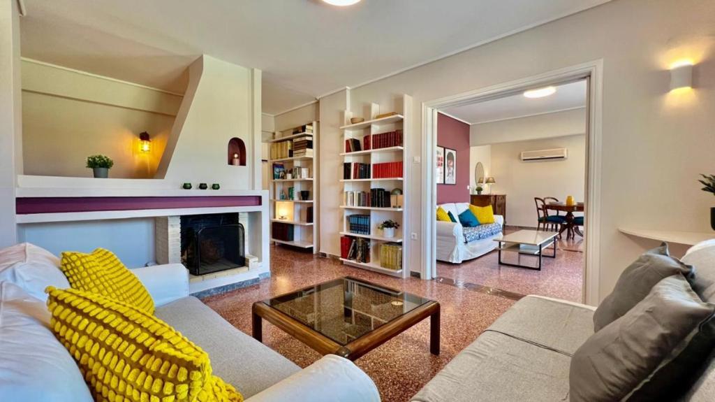 a living room with a couch and a fireplace at Beach house in the heart of Athens Riviera in Athens