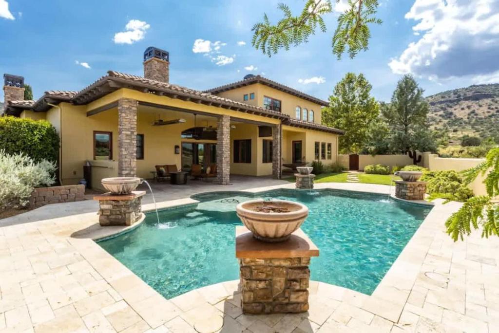 a home with a swimming pool and a house at Enchanting Sedona Villa with Views Spa and Pool in Sedona